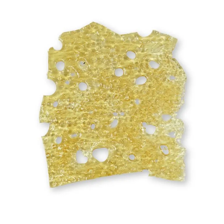Light golden cannabis shatter with a smooth, glass-like finish and multiple small air holes, displayed on a crisp white background.