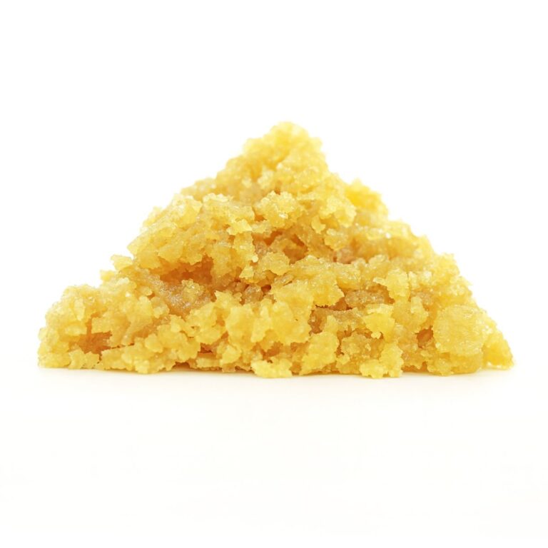 Golden-yellow cannabis concentrate crumble displayed against a clean white background, showcasing its coarse, grainy texture and pyramid-shaped formation.