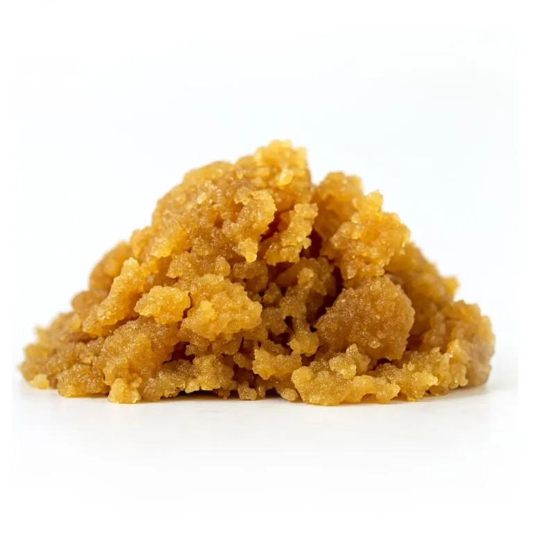 High-quality close-up of golden brown sugar crumble on a clean white background, showcasing natural texture and crystal detail.