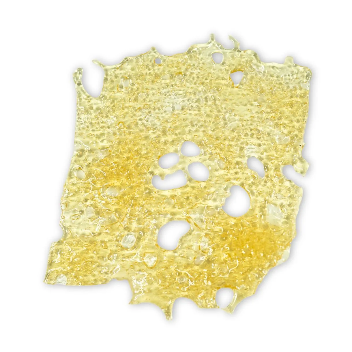 Close-up of Island Honey shatter — translucent golden cannabis concentrate with a glassy, bubbled texture and perforated edges on a crisp white background.