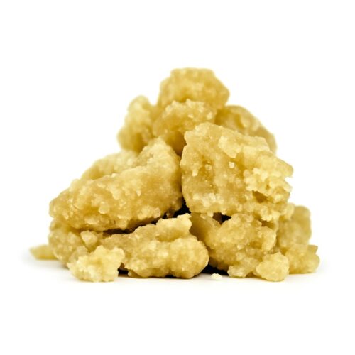 Golden cannabis crumble concentrate with a grainy, crumbly texture on a crisp white background with soft shadows