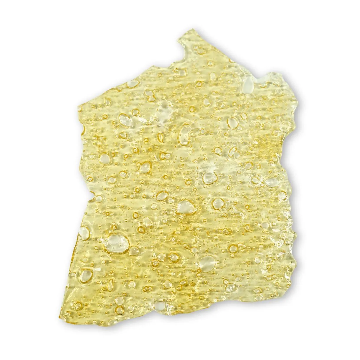 Close-up of RedBull shatter — translucent golden cannabis concentrate with a glassy texture and small air bubbles on a crisp white background.
