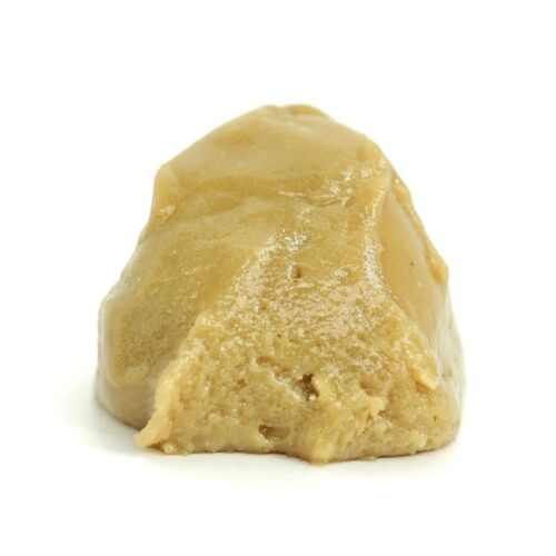 Golden cannabis budder concentrate on a white background, showcasing its smooth, creamy texture.