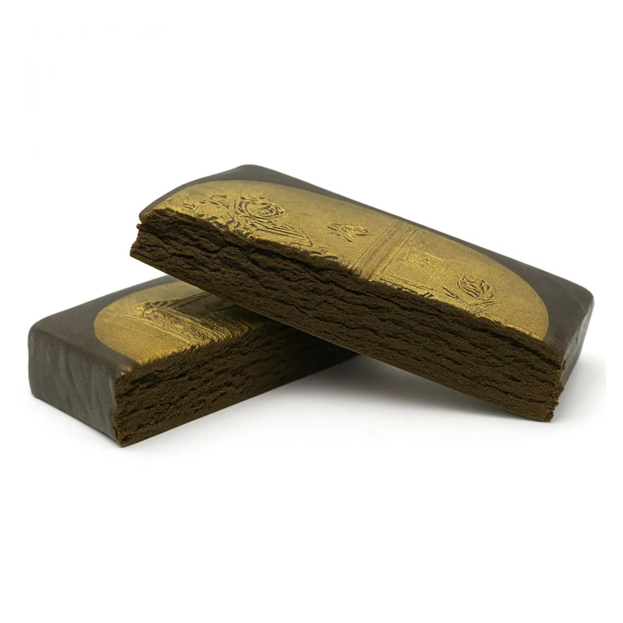 Two gold-stamped blocks of pressed hashish stacked on a white background, showcasing a smooth outer layer with embossed detailing and a crumbly interior texture.