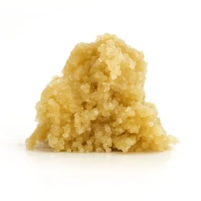 Photorealistic close-up of a light golden cannabis concentrate on a crisp white background.