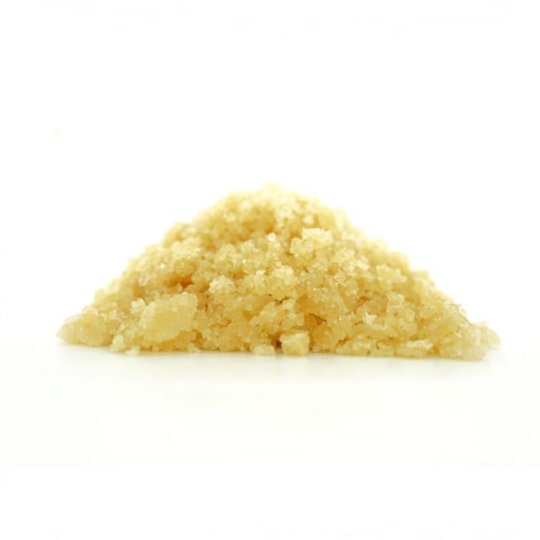 1.Golden cannabis sugar wax concentrate photographed on a crisp white background with visible crystal texture and natural depth