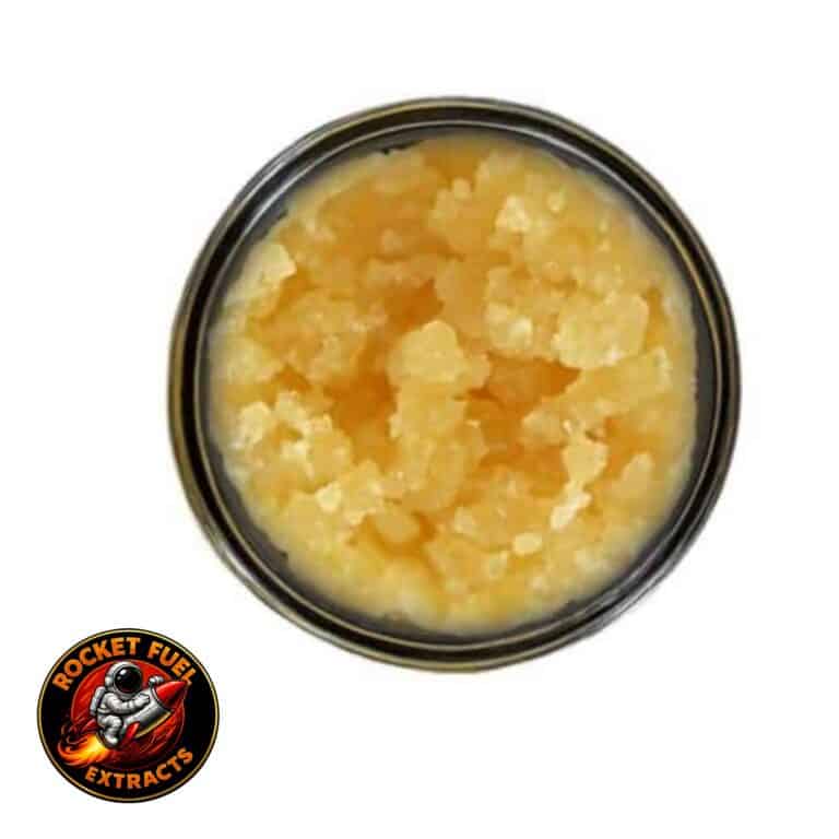 Open jar with golden, crumbly texture and granular consistency (close-up)