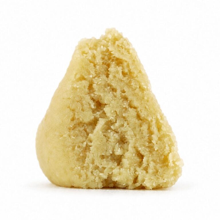 east coast sour diesel budder Close-up Pale yellow cannabis extract with a crumbly texture displayed upright on a white background
