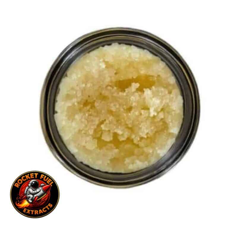 Open jar with golden, crumbly texture and granular consistency (close-up)