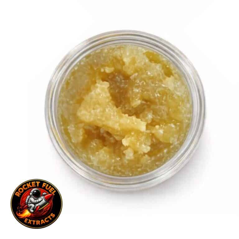 Open jar with golden, crumbly texture and granular consistency (close-up)