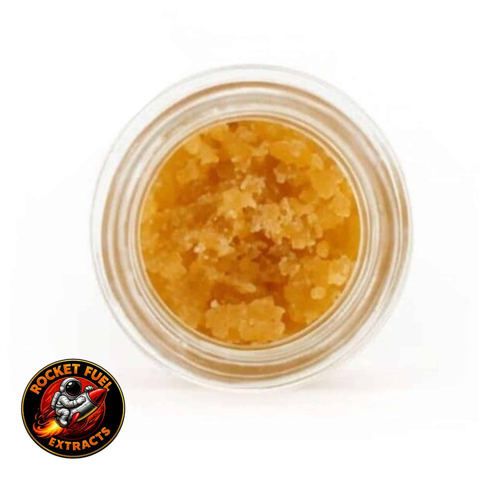 Open jar with golden, crumbly texture and granular consistency (close-up)