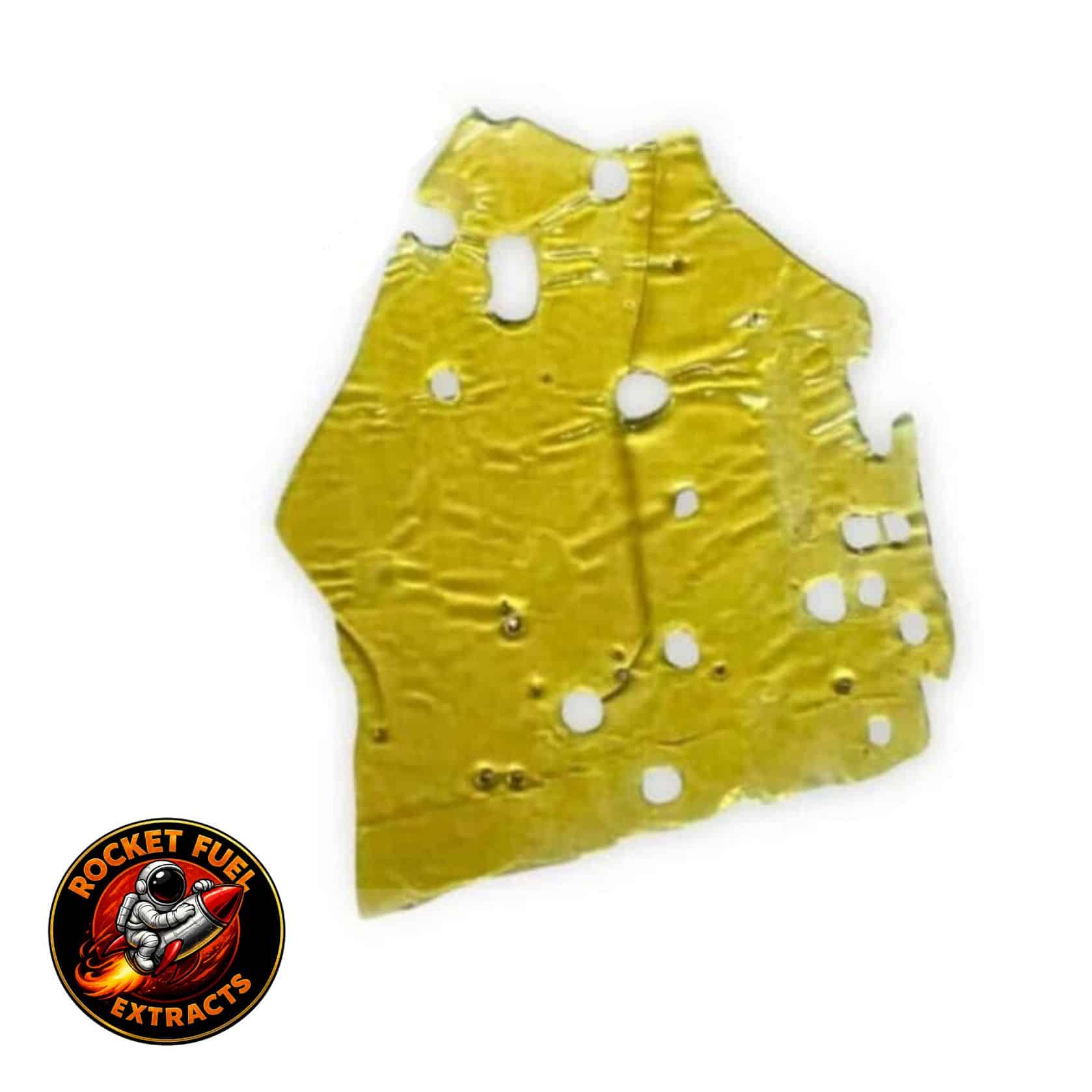 Close-up of a translucent golden cannabis concentrate slab with a porous, lace-like texture on a crisp white background.