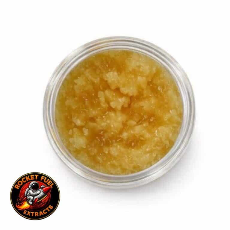 Open jar with golden, crumbly texture and granular consistency (close-up)