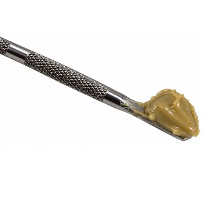 french macaron cannabis concentrate on a metal dab tool against a white background