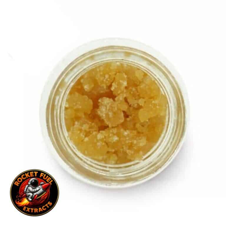 Open jar with golden, crumbly texture and granular consistency (close-up)