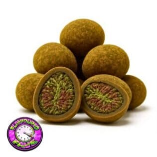 Close-up of round cannabis hash balls with one cut open to reveal a dense green and purple cannabis flower center.