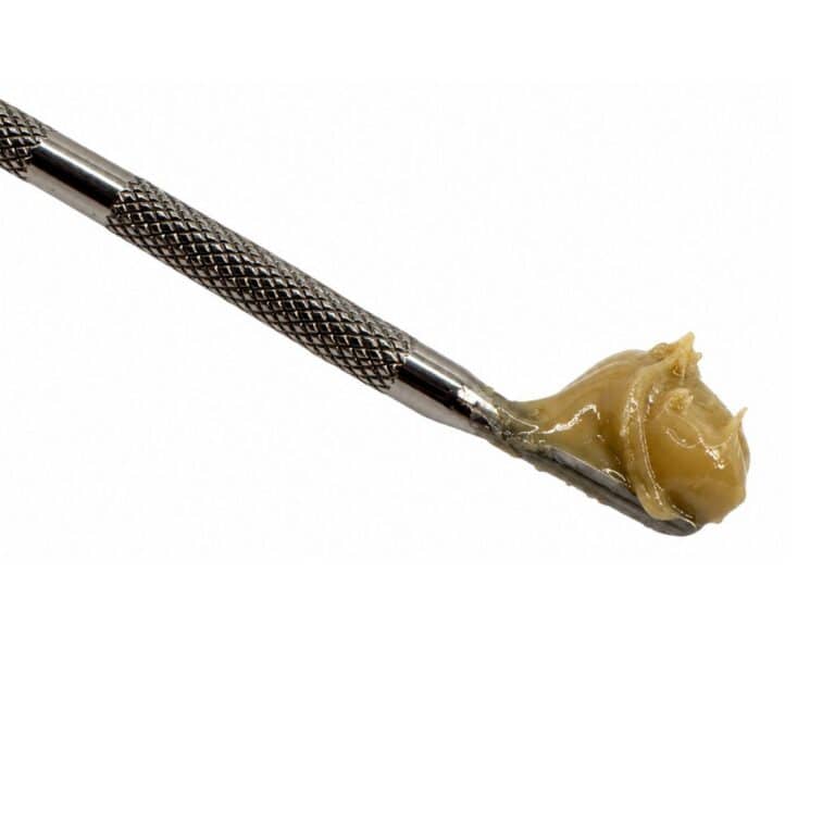 tar monster cannabis concentrate on a metal dab tool against a white background