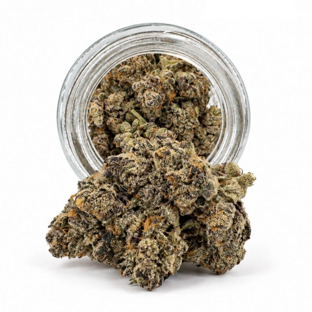 Dense cannabis flower with frosty trichomes in foreground, glass jar softly blurred on a crisp white background